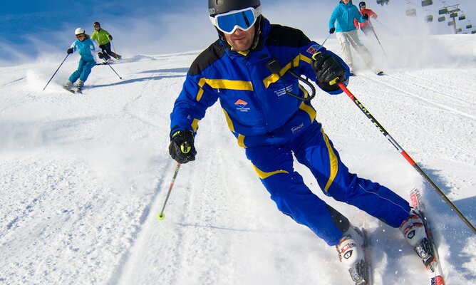 Skifahrer-Runde düst die Pisten hinab